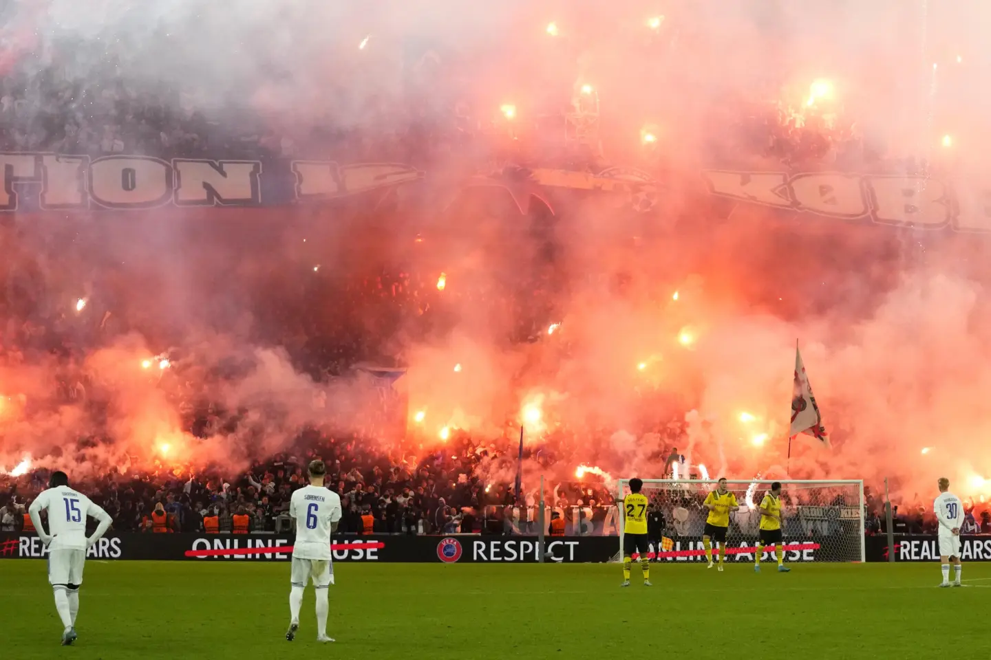 fireworks and sparklers in the crowd during football match